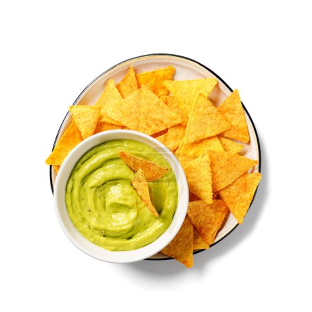 Photo for Avocado dip sauce guacamole with tortilla corn nachos chips in a white bowl . Isolated on white background. Top view. - Royalty Free Image