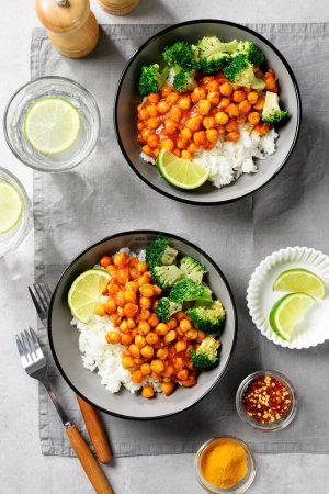 Photo for Chickpea curry with basmati rice and broccoli on gray background, top view - Royalty Free Image