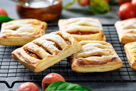 Photo for Homemade puff pastry pies filled with caramelized apples . - Royalty Free Image