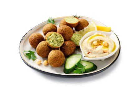 Photo for Plate of chickpeas falafel balls with hummus, vegetables  and lemon slices. isolated on white background - Royalty Free Image