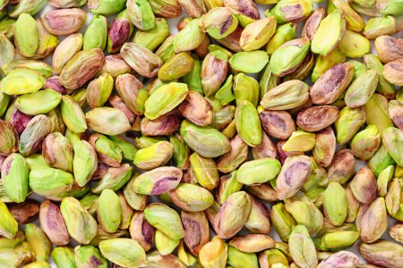 Peeled pistachio nuts background texture