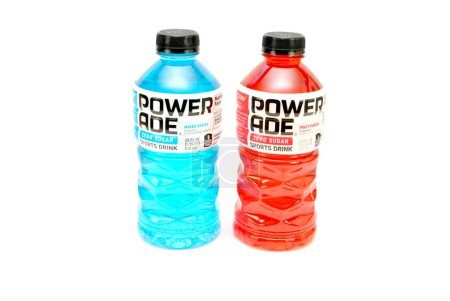 Photo for Powerade Bottles of Mixed Berry & Fruit Punch flavors Isolated Over White. Powerade replenishes vitamins and electrolytes lost during physical activities. Powerade is a division of Coca-Cola. - Royalty Free Image