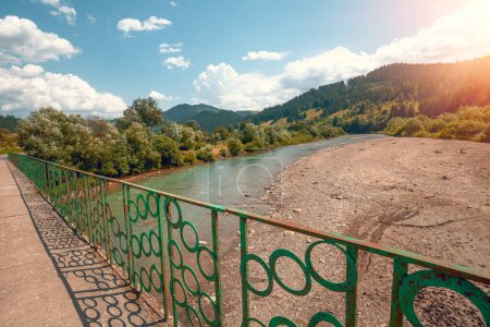 Photo for Beautiful summer landscape with mountain river on a sunny day. Bridge over the Black Cheremosh river, Ukraine,  Europe - Royalty Free Image