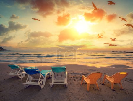 Photo for Seascape in the evening. Beach in the evening with chaise lounges - Royalty Free Image