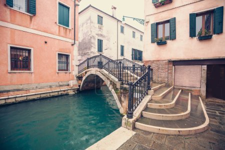 Venetian street on a rainy weather, bridge over the canal Italy. Rio Tera Primo, Parucheta Bridge