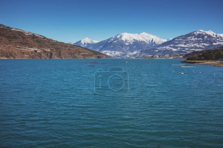 Photo for View of Serre-Poncon mountain lake in winter from the Savines Bridge. Hautes Alpes, France - Royalty Free Image