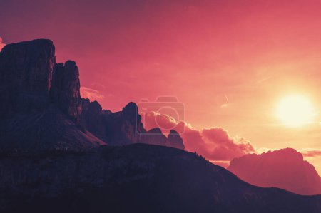 Silhouette of rocks against the sunset sky. Mountain landscape background. The dolomites in South Tyrol, Italy, Europe