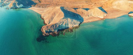 Panoramic view from above of the rocky coast. Seascape with a rocky beach and green water. Cabo de Gata-Nijar Reserve. Almeria, Spain