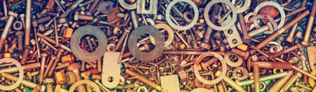 Abstract grunge colorful metal background made of fastening bolts, screws, and nuts. Horizontal banner