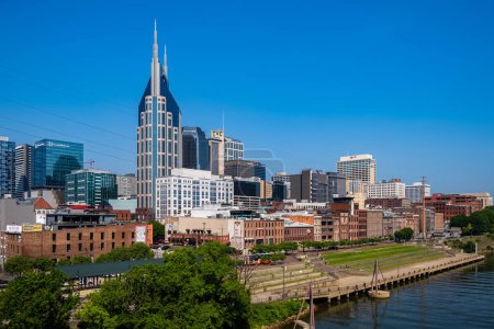 Photo for Nashville, Tennessee USA - May 12, 2023: Downtown skyline view from the vintage John Seigenthaler Pedestrian Bridge over the Cumberland River - Royalty Free Image