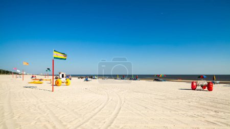 Photo for Gulf coast beach in Biloxi, Mississippi with water tricycles and lounge chairs. - Royalty Free Image