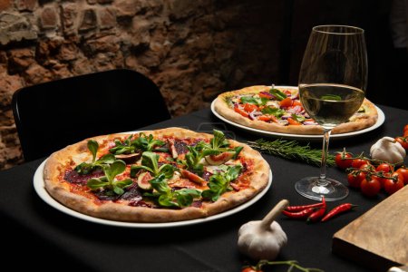 Photo for Pizza on the table in the restaurant. Italian cuisine theme. - Royalty Free Image