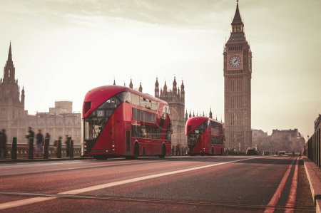 Photo for Two Double Decker red London Bus on the Westminster Bridge and Big Ben Tower in the background. London public transportation. - Royalty Free Image