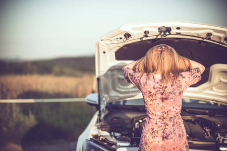 Photo for Crying woman in front of a broken car waiting for roadside assistance. Copy space. - Royalty Free Image