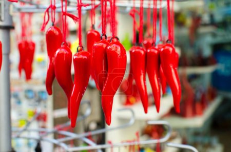Photo for A traditional Neapolitan souvenir on the oudau - cornetto portafortuna. Red pepper or horn is one of the oldest mascots. Horizontal orientation. Selective focus. - Royalty Free Image