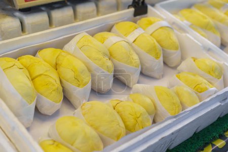 Freshly peeled durian fruit, known as the 'king of fruits', packaged neatly in cling film and displayed for sale