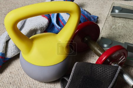 Photo for Kettlebell. Fitness objects, kettlebell, dumbbell, towel and a scale - Royalty Free Image