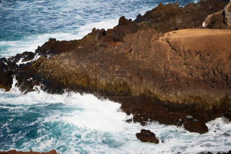 Sea and rocks. Cliffs in El Golfo, a coastal village on the island of Lanzarote (Spain).
