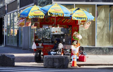 Photo for New York (United States), March 24, 2024. Street food vendor. Mobile food stall on a street in New York. Sell simple things like hot dogs, hamburgers, baggle, drinks, etc. - Royalty Free Image