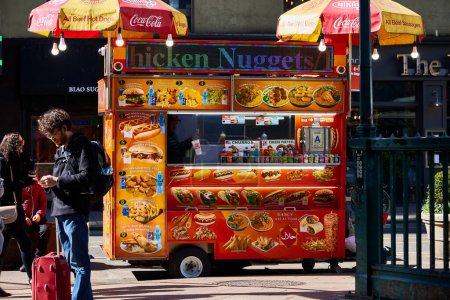 Photo for New York (United States), March 24, 2024. Street food vendor. Mobile food stall on a street in New York. Sell simple things like hot dogs, hamburgers, baggle, drinks, etc. - Royalty Free Image