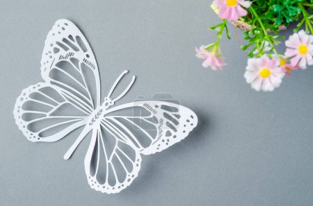 Photo for Butterfly Paper Cut with flower on grey colour background - Royalty Free Image