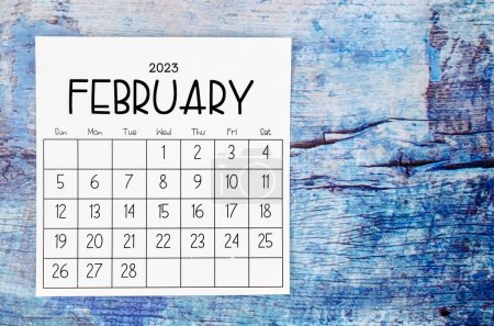 February 2023 Monthly calendar for 2023 year on old blue wooden background.