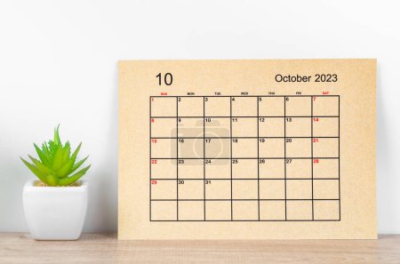 October 2023 Monthly calendar for 2023 year on wooden table.