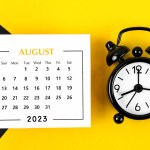 August 2023 Monthly calendar for 2023 year with black colour alarm clock on beautiful background.
