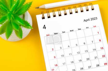 Photo for April 2023 Monthly desk calendar for 2023 with pencil on yellow background. - Royalty Free Image