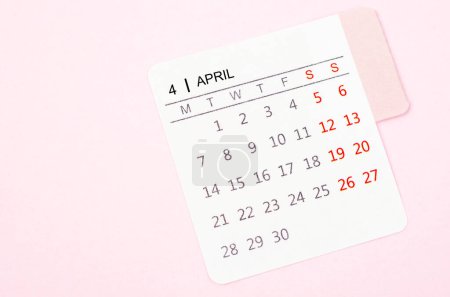 Photo for Mini April calendar on a pink color background. High resolution and copy space for all your text or message. - Royalty Free Image