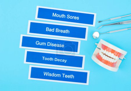 Photo for Dentures model with dental disease on blue background. - Royalty Free Image