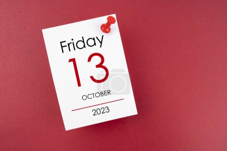 Photo for Calendar Friday the 13th October 2023 and push pin on red background. - Royalty Free Image
