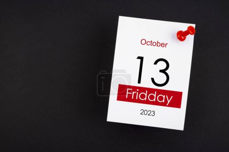 Photo for Calendar Friday the 13th October 2023 and push pin on black color background. - Royalty Free Image