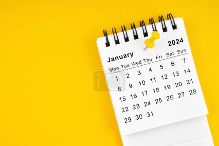 January 2024 Monthly desk calendar for 2024 year with thumbtack on yellow background.