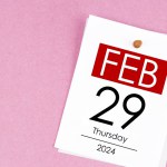 February 29th calendar for February 29 and wooden push pin on pink background. Leap year, intercalary day, bissextile.