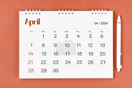 April 2024 Monthly desk calendar for 2024 year and pen on red color background.
