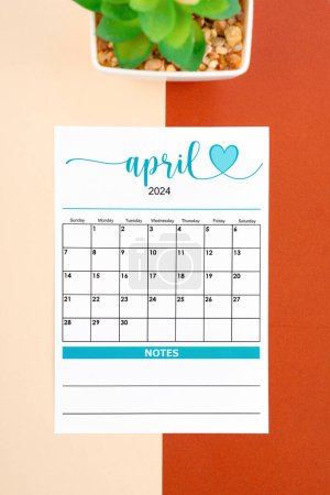 April 2024 calendar page with plant pot on beautiful background.