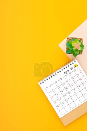 Calendar page for April 2024 and houseplant on yellow background, planning concept.