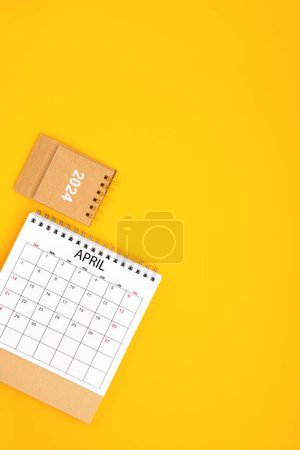 2024 April Desk Calendar On Yellow Background, Position with copy space On Yellow Background. Planning concept.