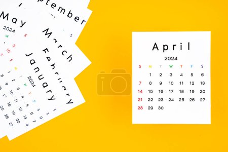 Calendar page for April 2024 on a yellow background.