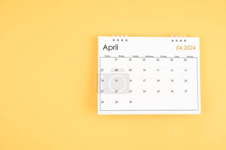 April 2024 desk calendar on yellow color background, position with copy space. Time planning day concepts.
