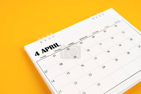 April 2024 desk calendar on yellow color background. Time planning day concepts.