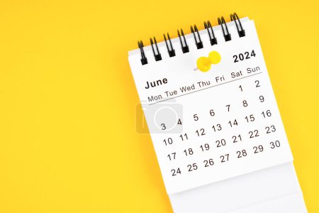 June 2024 Monthly desk calendar for 2024 year with thumbtack on yellow background.