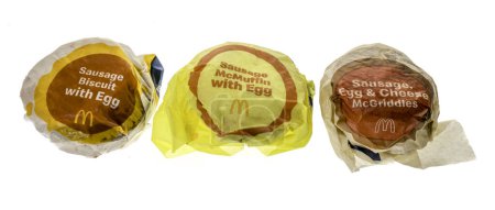 Photo for Winneconne, WI - 20 February 2024: A package of McDonalds sausage, egg, and cheese Mcgriddles, McMuffin and biscuit breakfast sandwiches on an isolated background. - Royalty Free Image