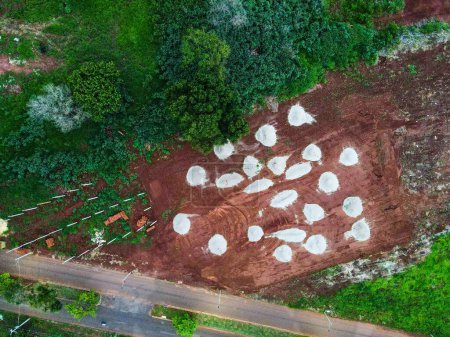 Aerial top down of piles of concrete in clay field Tangara da Serra in Mato Grosso Brazil
