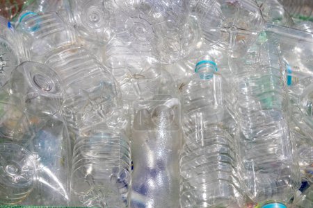 Many discarded clear plastic PET bottles in dumpster, Kanazawa, Japan.