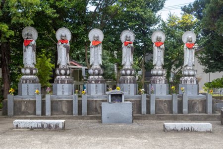 Photo for Stone statues (public art) of Ojizou san, with red bibs. Kanazawa, Japan. TRANSLATION: left-to-right: long life, child-giving, medicine teacher, world peace, bokefuki, inviting luck. - Royalty Free Image