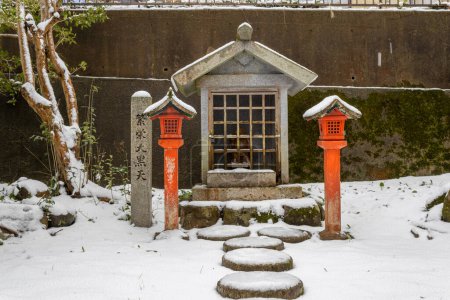 Small shrine in winter. Tougorou jinja shrine, Kanazawa, Japan. TRANSLATION: prosperity from daikokuten (one of the Seven Lucky Gods).