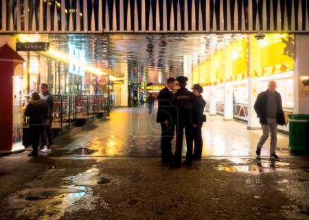 Photo for A group of employees is having a chat on a rainy night in Tivoli Gardens in Copenhagen, Denmark. - Royalty Free Image