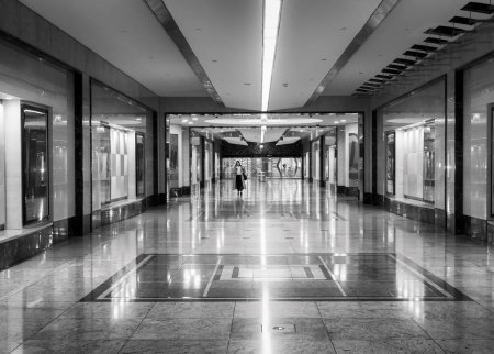 Photo for A woman is walking in a tunnel under a large shopping center. The tunnel interior looks like a palace. - Royalty Free Image